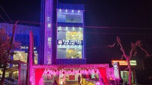 A hotel with a prominent sign reading "THE HOTEL SS GALAXY" and a brightly lit facade. - Hotel The SS Galaxy (Raebareli)