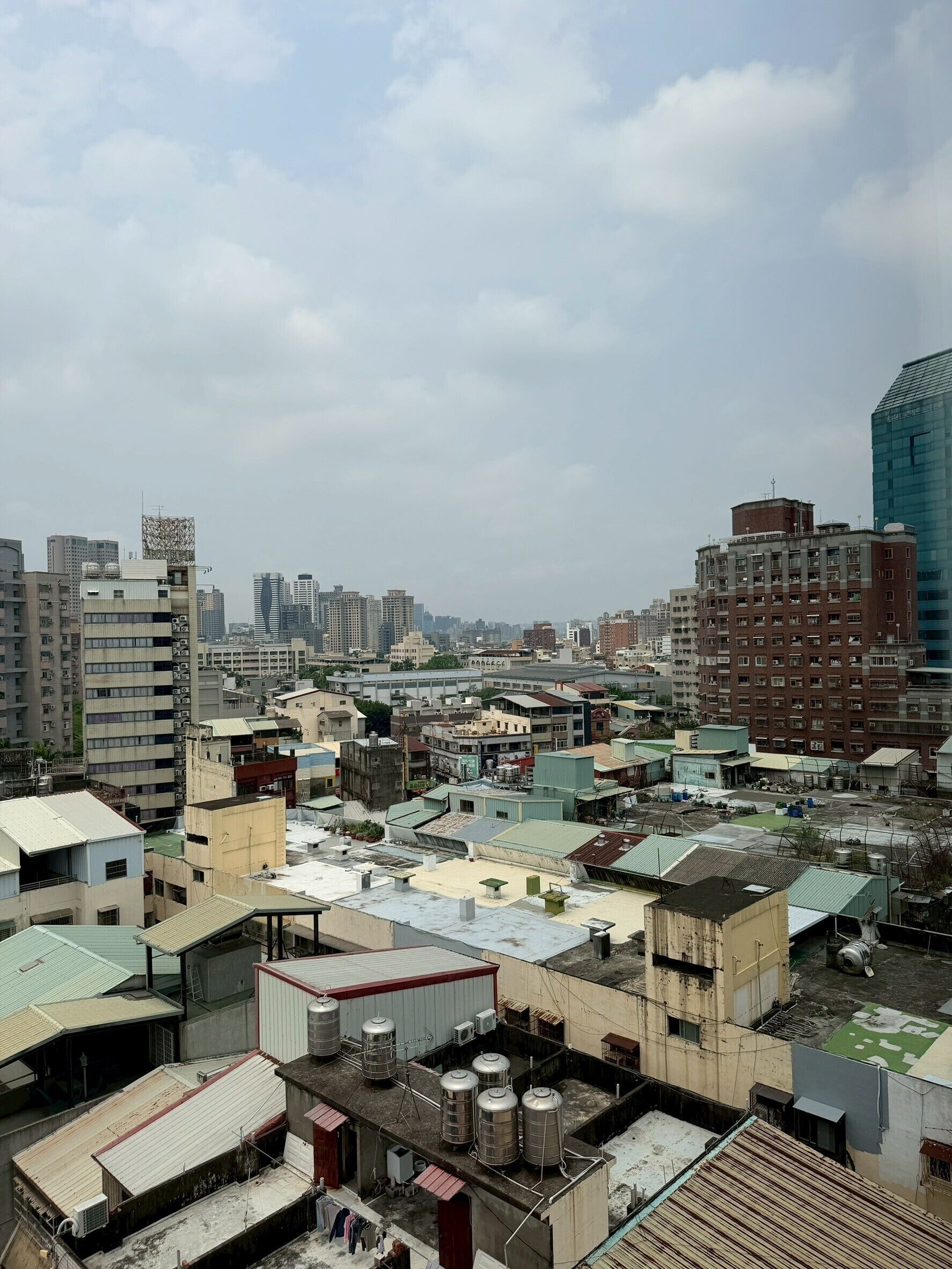 A cityscape with various buildings, including residential and commercial structures, and a mix of older and modern architecture.