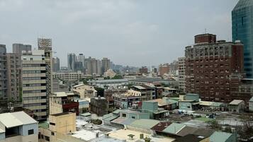 A cityscape with various buildings, including residential and commercial structures, and a mix of older and modern architecture.