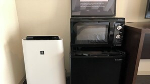 A compact kitchen setup with a Sharp refrigerator, an S-Cubana microwave, and a small black appliance, likely a coffee maker or toaster, on a dark countertop. - 2min walk from Nakano Station 1min walk to Nakano Broadway MAX4 Guests(2) (中野区中野)