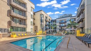 A modern hotel with a swimming pool, sun loungers, and multiple balconies. - 2-bedroom apt in Marina del Rey with pool, jacuzzi, gym, free parking! (Marina del Rey)