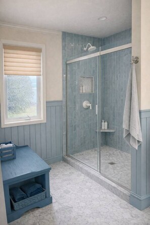 A bathroom with a glass shower enclosure, a vanity with storage, and a window. - Waterfront Home|Dock & Kayaks|5 Min to Baileys Harbor (Baileys Harbor)