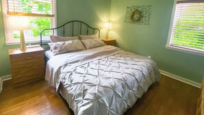 A bedroom with a bed, a ceiling fan, a nightstand, and a window with blinds. - Sweet Home with Ample Parking. Only 1-min to Freeway! (Sacramento)