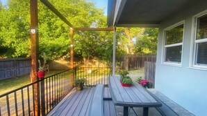 A wooden deck with a picnic table and potted plants. - Sweet Home with Ample Parking. Only 1-min to Freeway! (Sacramento)