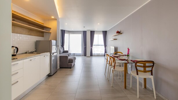 A modern kitchen with white cabinets, a built-in oven, and a stainless steel refrigerator. - Ocean View Apt - 1BR T2-613 (Chalong)