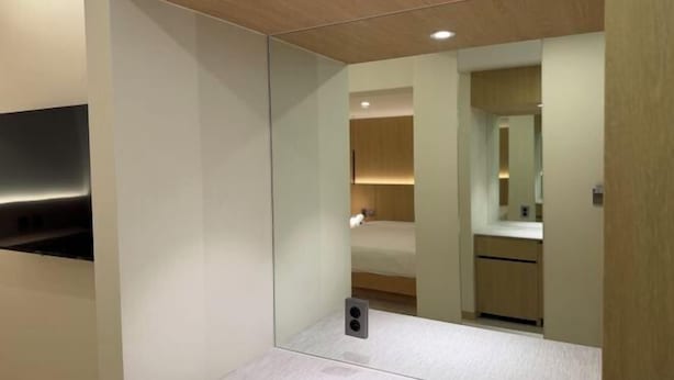 A modern bathroom with a mirror, a sink, and a shower area. - Lamer Hotel & Seawater Spa Busan (Busan)