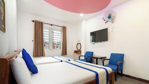 A hotel room with two beds, a TV, a desk, and a chair. - Collection O District Tan Phu - Tien Thang Hotel  (Ho Chi Minh City)