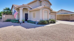 A single-story house with a beige facade, a tiled roof, and a front entrance with a black door. - Labor Day Weekend Special: Flexible Check-In/Out! (Phoenix)
