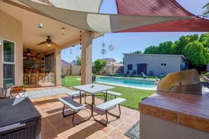 A patio with a pool, outdoor seating, and a barbecue area. - Patio Oasis w/ Wet Bar, Pool, Spa & Grill (Phoenix)
