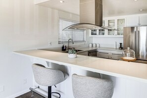 Fridge, stovetop, dishwasher, coffee/tea maker