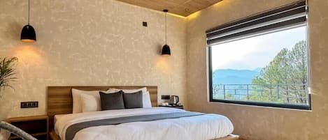 A bedroom with a bed, bedside tables, a window with a view, and pendant lights.