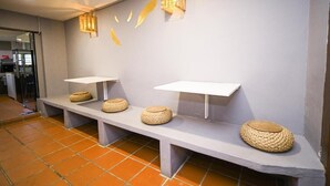 A modern interior with a grey wall, two white shelves, and woven baskets. - Swing & Pillows at 87 Chulia St (George Town)