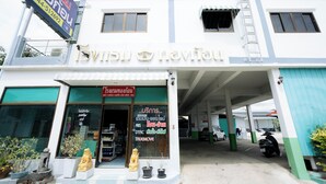 A building with a sign that reads "Move Here" and a smaller sign with a phone number. - Thongkon Hotel (Surin)