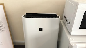 A white, modern, cylindrical device with a control panel and a small logo on the front, placed next to a white appliance with a vented front. - 2min walk from Nakano Station 1min walk to Nakano Broadway MAX6 Guests(4) (中野区中野)