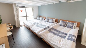 A hotel room with two beds, a wooden floor, a large window with curtains, and a plant on the left. - 2min walk from Nakano Station 1min walk to Nakano Broadway MAX6 Guests(4) (中野区中野)