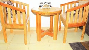 A wooden table with two chairs, a small decorative item, and a tiled floor. - Flo Homes White House Apartments, Thome Nairobi (Nairobi)