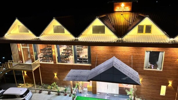 A modern building with a wooden facade and multiple triangular roofs. - The Chail Pine Orchard Resort (Chail)