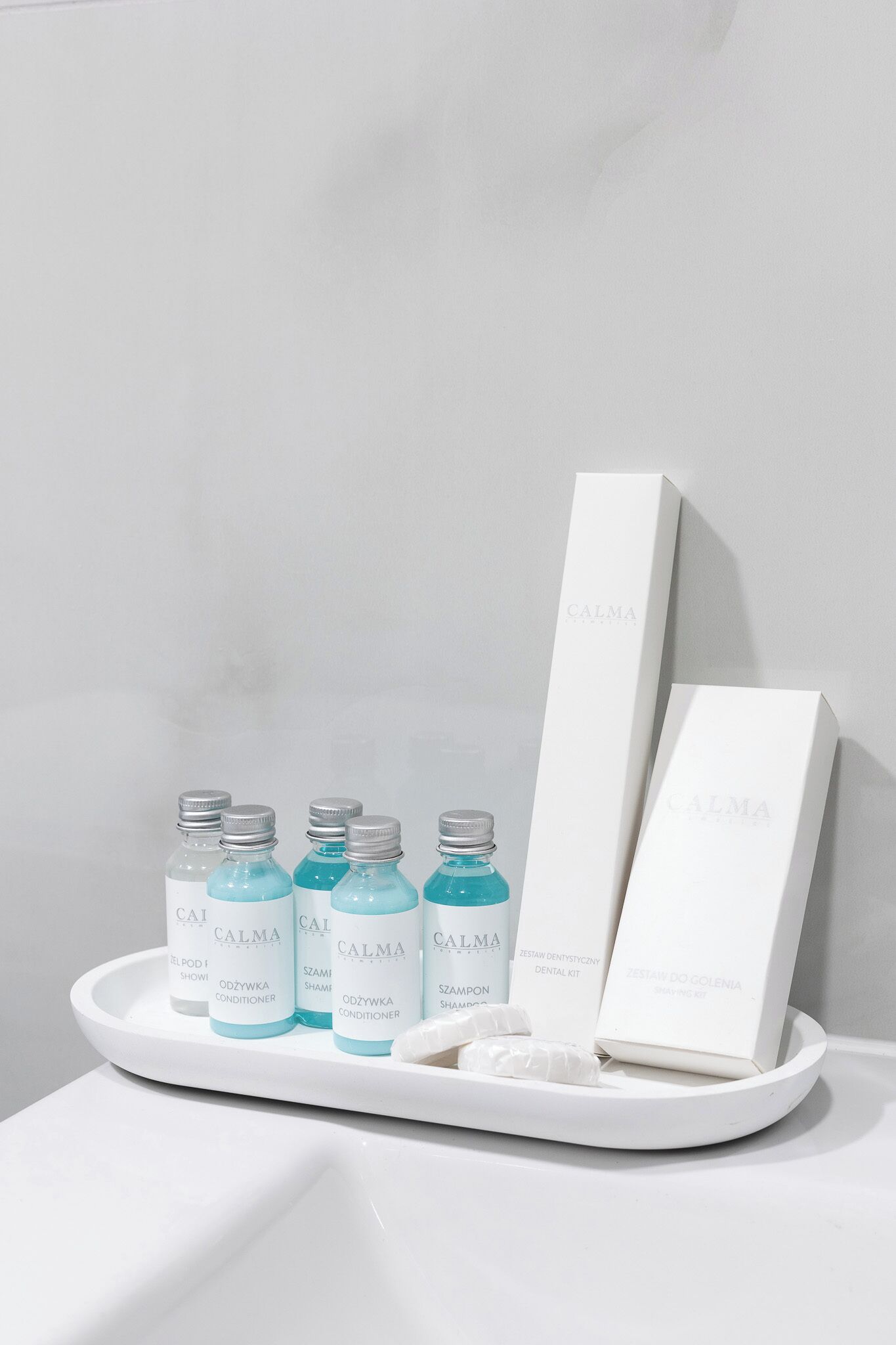 A tray with four bottles of CALMA products and two boxes.