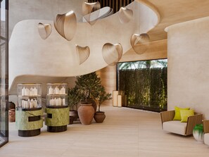 A modern lobby with a large window, a reception desk, and a seating area with a sofa and cushions.