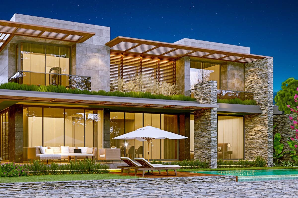 A modern two-story house with a pool, outdoor seating, and a stone facade.