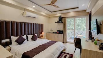 Desk, laptop workspace, iron/ironing board, bed sheets