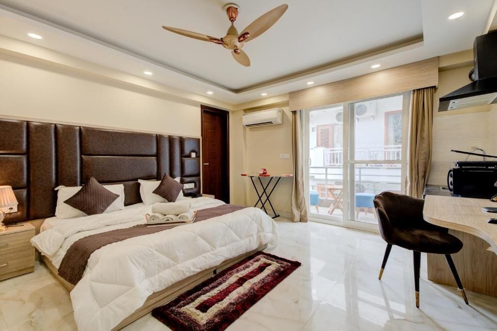 Desk, laptop workspace, iron/ironing board, bed sheets