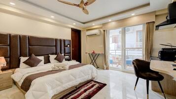 Desk, laptop workspace, iron/ironing board, bed sheets