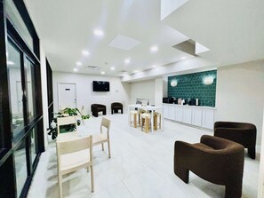 A modern interior with a dining area, kitchen, and seating space.