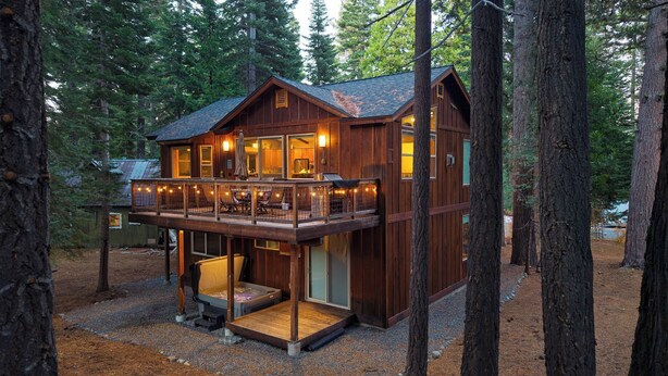 A wooden cabin with a balcony, a covered porch, and a deck. - Cozy Tahoe Retreat w/ Hot Tub, Movie Room & Forest Views 10th ave 2 by Avantstay (Tahoma)
