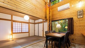 A traditional Japanese-style room with tatami flooring, a wooden ceiling, and a dining table with chairs. - rinne 2nd living Sauna Villa Nasu (Nasu)