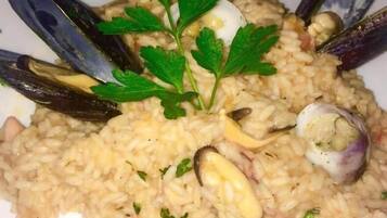 A plate of seafood risotto garnished with parsley.