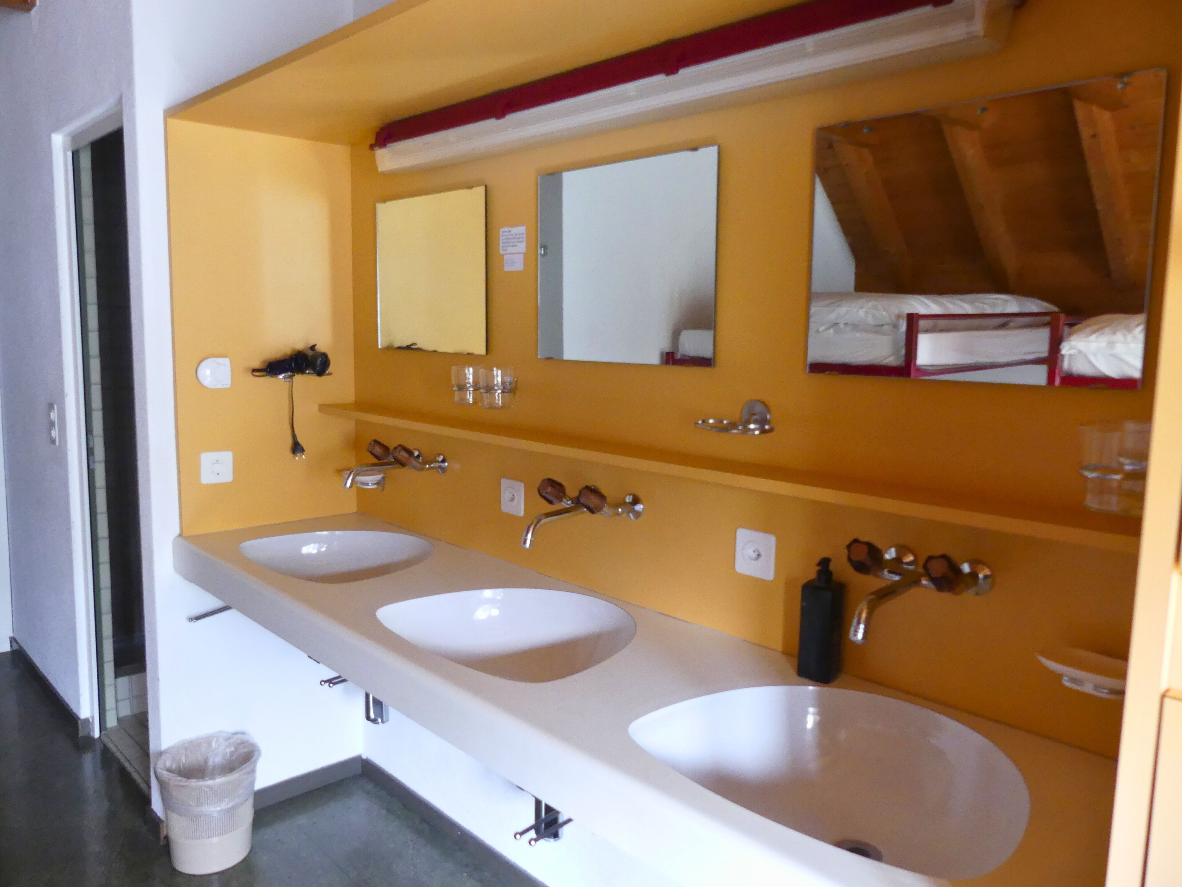 A bathroom with two sinks, mirrors, and a towel rack.