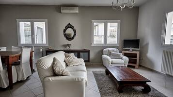 Superior Apartment, Garden View | Living area | Flat-screen TV