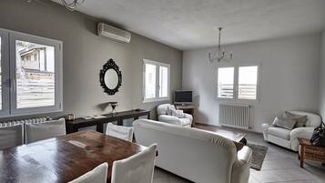 Superior Apartment, Garden View | Living area | Flat-screen TV