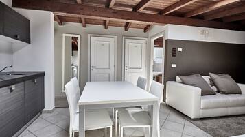 Deluxe Apartment, 3 Bedrooms | Living area | Flat-screen TV