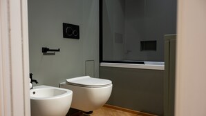A modern bathroom with a bidet, a toilet, and a sink. - Cosy is a very cozy modern facility in soft colors, center of Bari (Bari)