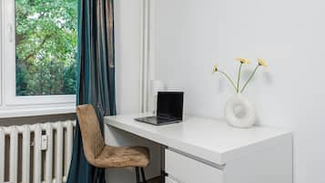 Desk, laptop workspace, blackout curtains, iron/ironing board
