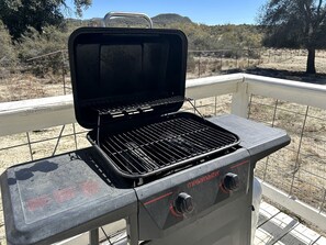 A portable grill with a control panel, set on a balcony with a view of a dry landscape. - Shabby Chic Warner Springs Rental at a Ranch Ideal for Glamping in California (Warner Springs)