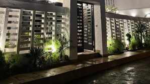 A modern multi-story building with a prominent entrance, large windows, and a well-lit facade. - ABM Green (Tangier)