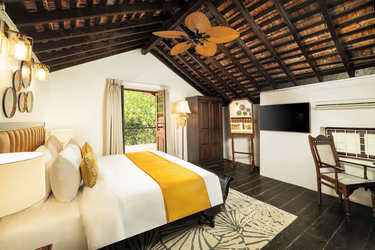 Ein Schlafzimmer mit einem Bett, einem Nachttisch, einer Lampe und einem Deckenventilator.