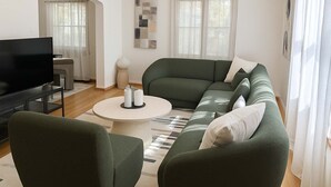 Una sala moderna con un sofá verde, una mesa de centro redonda y un televisor de pantalla plana.