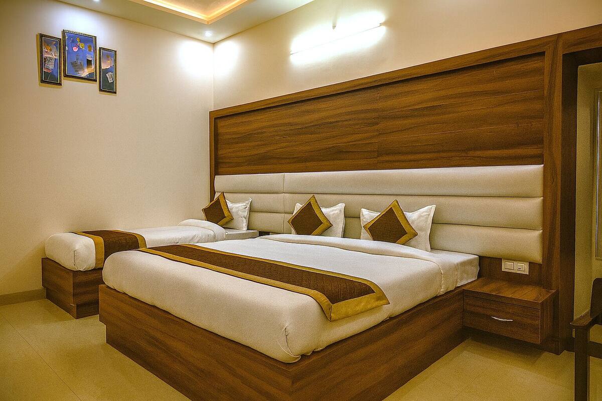 A double bed with a wooden headboard, two bedside tables, and a nightstand.