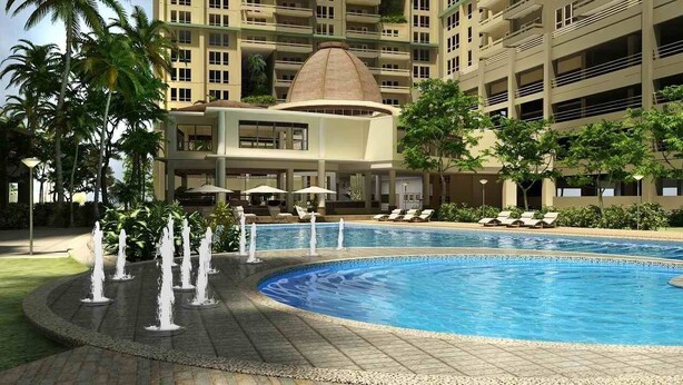 A hotel pool area with multiple fountains, lounge chairs, and a large building in the background. - Splendid 2 Bedroom in Tivoli Garden Residences, high floor, spacious, balcony (Mandaluyong City)
