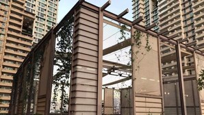 A modern building with a metal and glass facade, surrounded by high-rise residential buildings. - Splendid 2 Bedroom in Tivoli Garden Residences, high floor, spacious, balcony (Mandaluyong City)