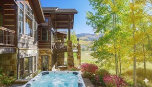 A wooden cabin with a hot tub and a view of a forested valley. - Private Estate 🏔️ 9,400 sq ft ✨ Game Room 🎱 Steam Sauna 💦 1.5 Acres 🧖‍♀️ Spa (Silverthorne)