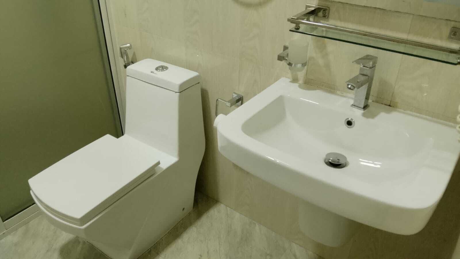 A bathroom with a toilet and a sink.