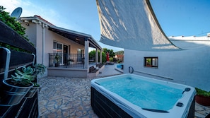 A swimming pool, outdoor seating, and a covered patio area.