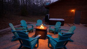 A fire pit surrounded by four Adirondack chairs in an outdoor setting. - Sleeps 30 • Theater • Game Room • Big Cedar Area (Ridgedale)
