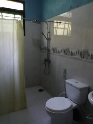 A small bathroom with a toilet, a shower, and a sink. - Colombo Airport Field View Villa (Andiambala)