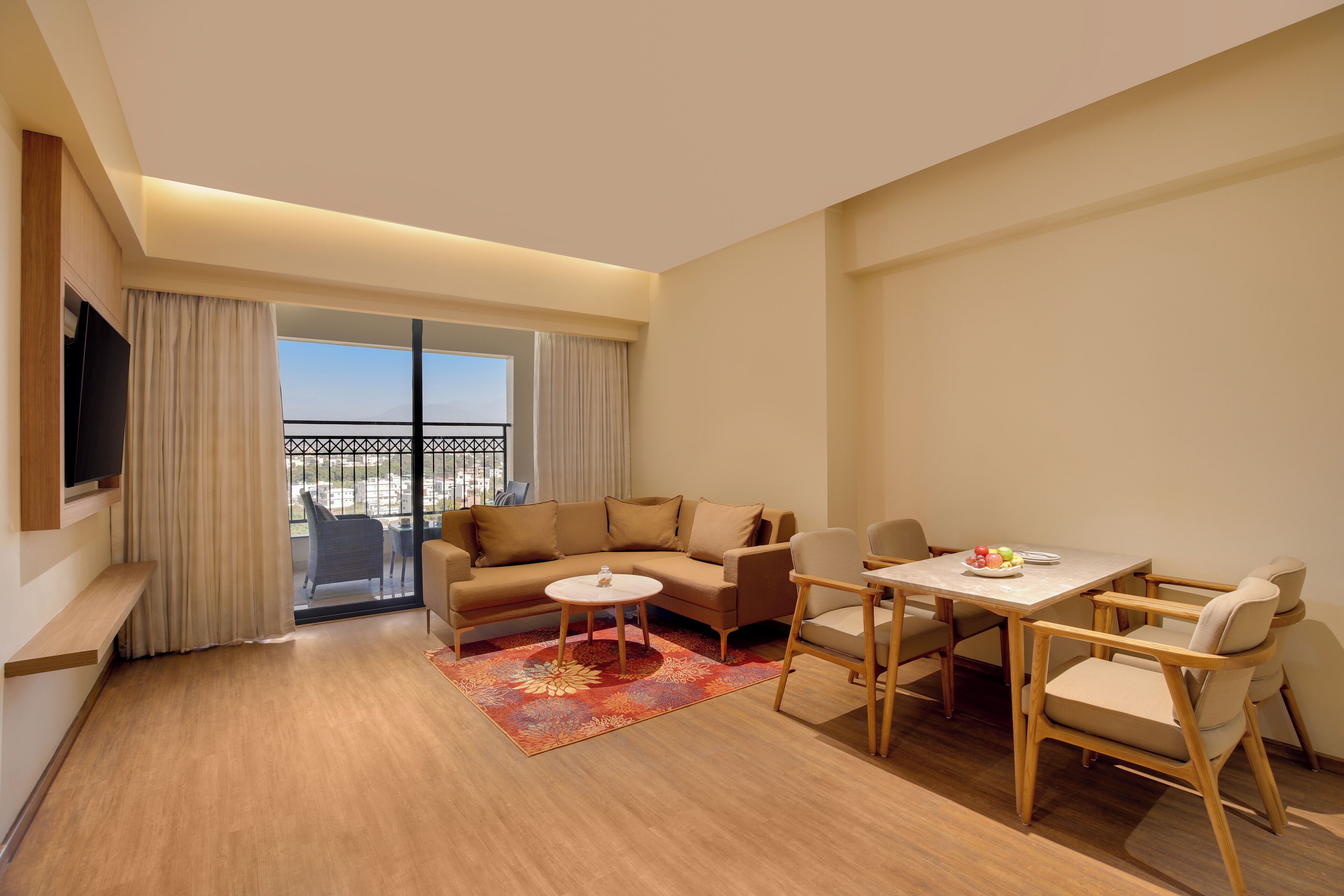A modern living room with a sofa, coffee table, and dining area.